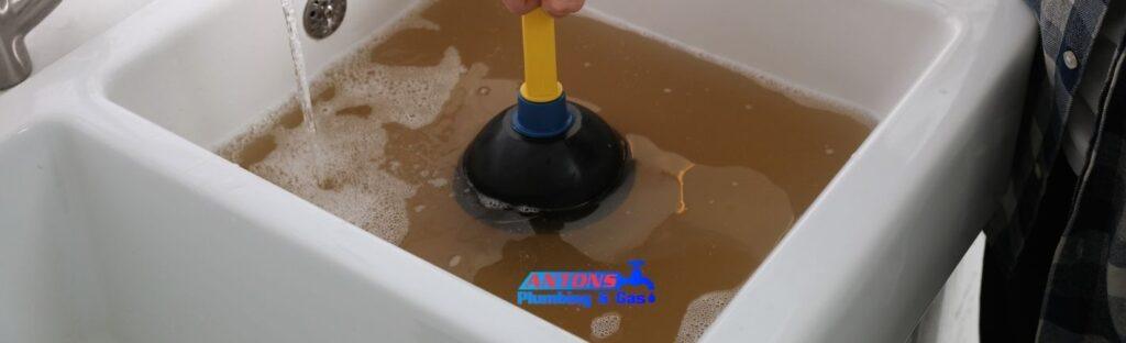 How a Drain Cleaning Plumber Helps Avoid Costly Business Downtime